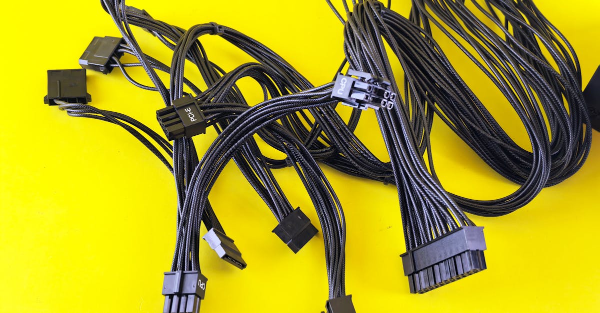 black computer cables splayed on a vibrant yellow surface highlighting technology connection themes